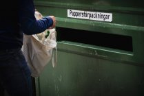 Person throwing away garbage — Stock Photo