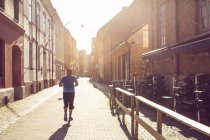 Man running in old town — Stock Photo