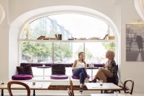 Businesswomen talking in tea room — Stock Photo