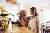 Women smiling by bar counter — Stock Photo