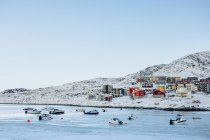 Frozen sea with residential buildings — Stock Photo