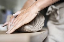 Female potter rolling clay — Stock Photo