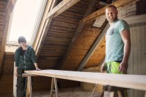 Couple working to renovate old attic — Stock Photo