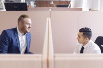 Colleagues talking in cubicles — Stock Photo