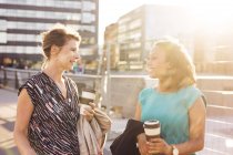 Businesswomen talking and smiling — Stock Photo