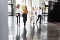 Colleagues walking through lobby — Stock Photo
