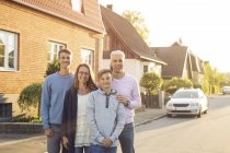 Family with two sons posing on street — Stock Photo