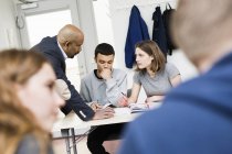 Teacher talking with students in classroom — Stock Photo