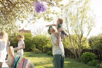 Father playing with son in garden — Stock Photo