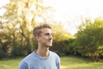 Portrait of young blond man looking away — Stock Photo