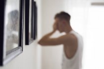 Pensive young man in room — Stock Photo