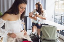 Two young women with baby boy (2-5 months) in cafe — Stock Photo