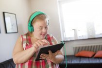 Frau mit Down-Syndrom nutzt digitales Tablet — Stockfoto