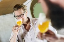 Two men drinking beer in local brewery — Stock Photo