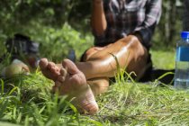 Woman sitting on grass  at forest during daytime — Stock Photo