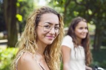 Two teenage girls (14-15) in park — Stock Photo