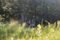 Man and woman walking in meadow — Stock Photo