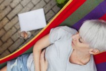 Overhead view of woman relaxing on hammock — Stock Photo