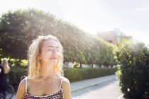 Portrait of blonde teenage girl (14-15) wearing eyeglasses in park — Stock Photo