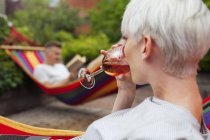 Couple relaxing on hammocks during daytime — Stock Photo