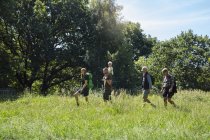 Family walking in meadow during daytime — Stock Photo