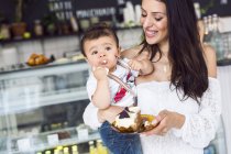 Mother with baby son (6-11 months) in cafe — Stock Photo