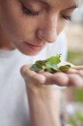Woman smelling fresh herbs, close-up — Stock Photo