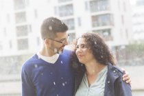 Portrait of mid adult couple standing in rain — Stock Photo