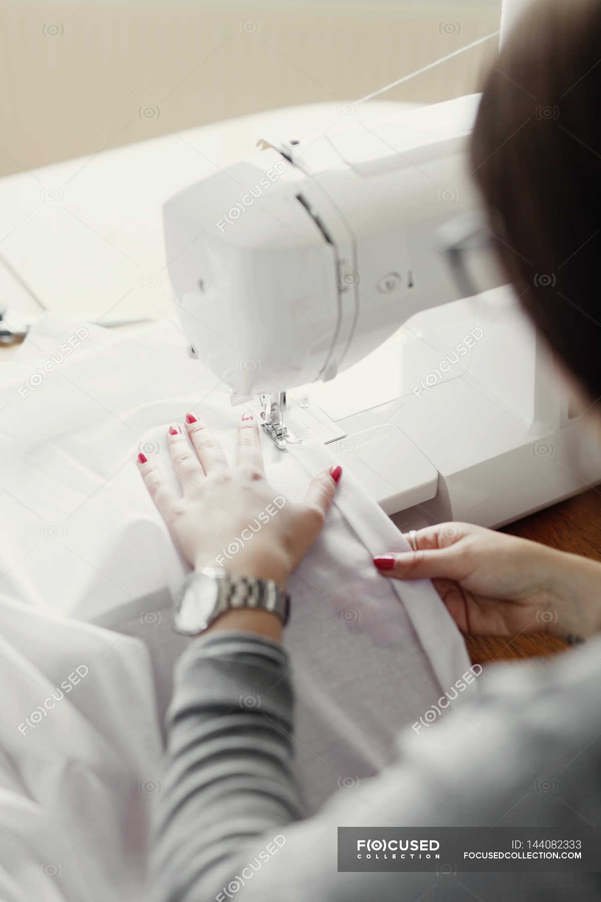 Fashion designer using sewing machine — machinery, selective focus Stock Photo 144082333