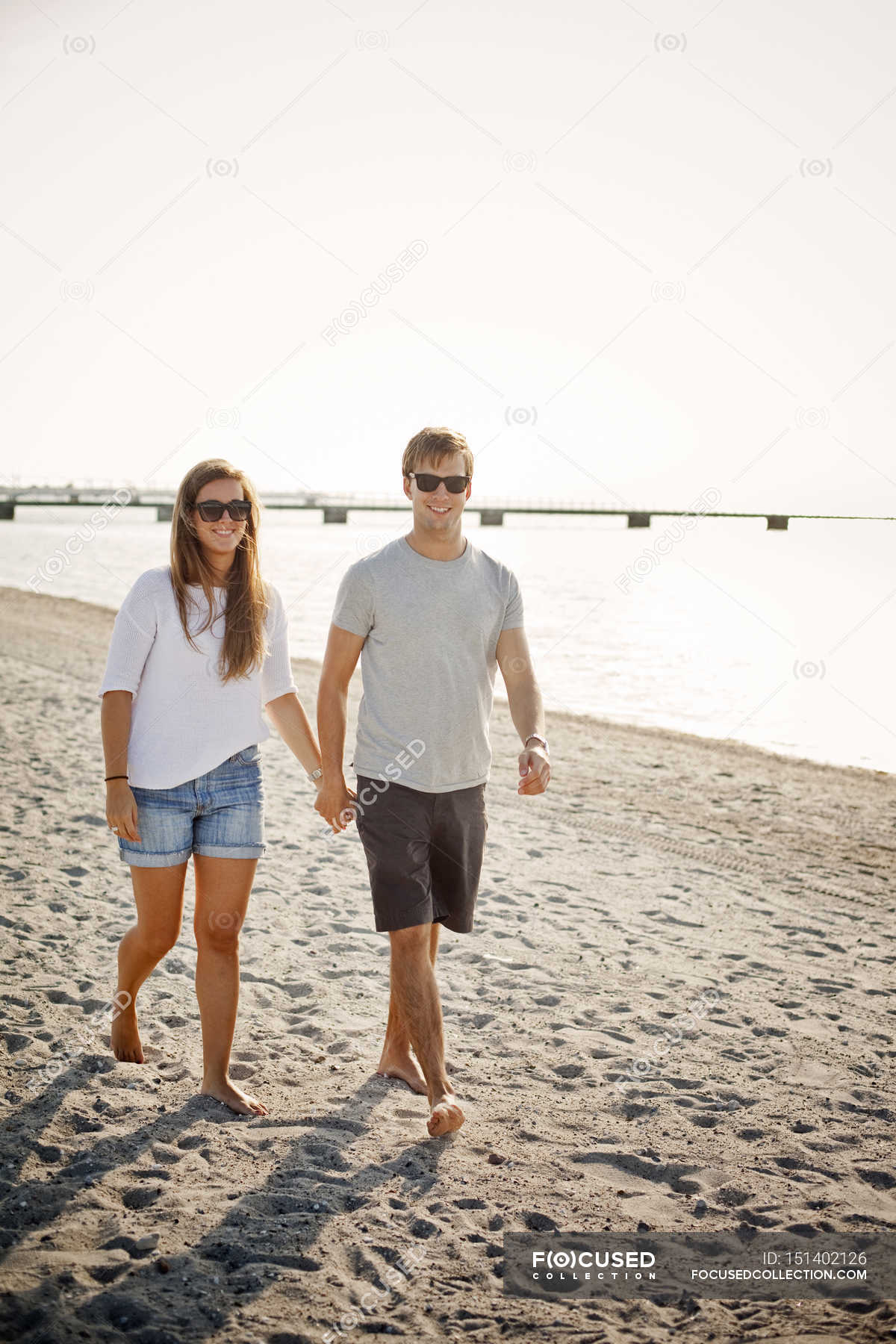 couple holding hands on beach