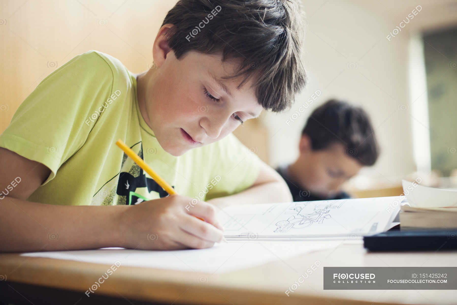 Boy writing in book — 10 11 Years, concentration - Stock Photo | #151425242