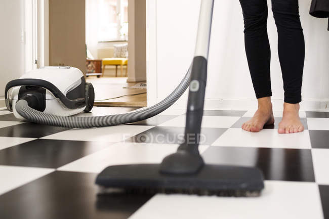 Woman with vacuum cleaner — Stock Photo