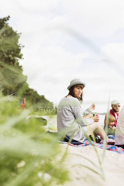 Woman sitting with friends — Stock Photo