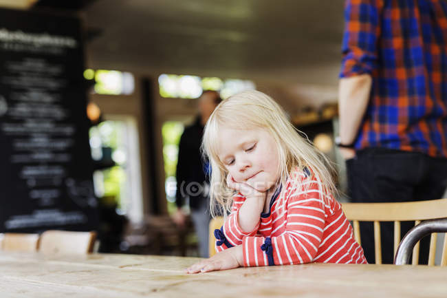 Girl looking down while sitting — Stock Photo