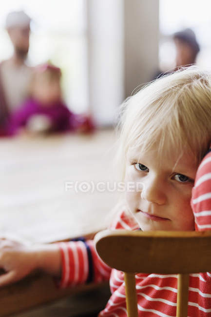 Girl sitting at cafe table — Stock Photo