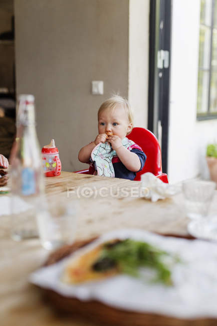 Baby boy eating napkin — Stock Photo