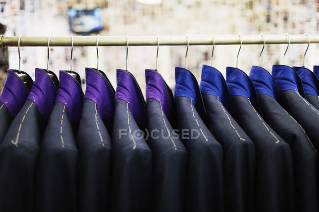 Suits hanging on rack — Stock Photo