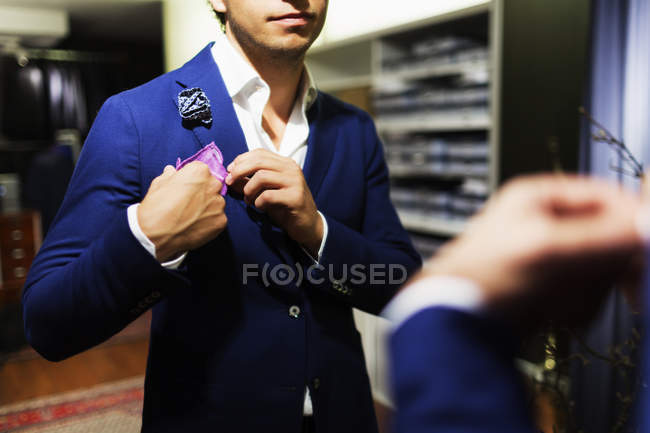 Male customer adjusting handkerchief — Stock Photo