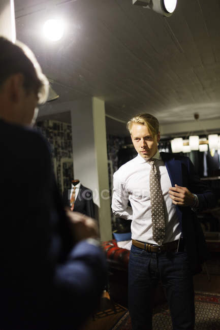 Male customer trying on suit — Stock Photo