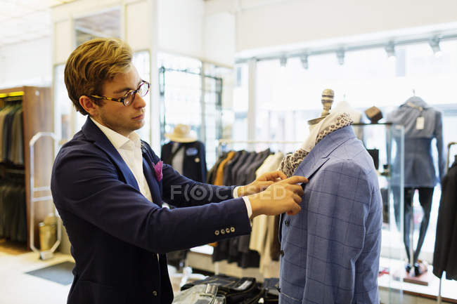 Designer fixing suit — Stock Photo