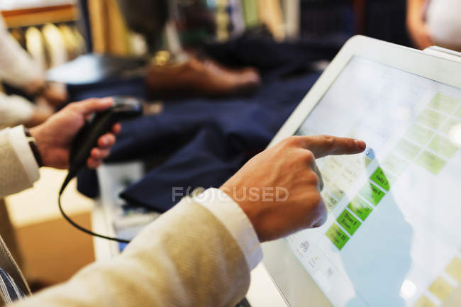 Cashier pointing on computer monitor — Stock Photo