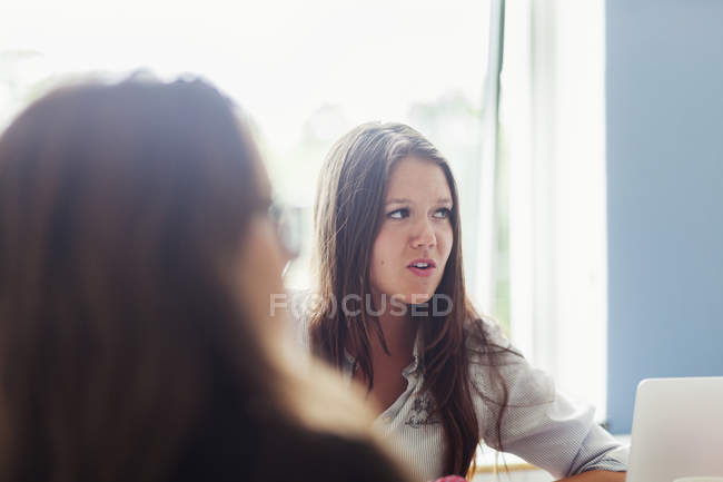 Young businesswomen at office meeting — Stock Photo