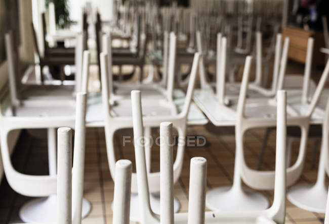 Upside down chairs on table — Stock Photo