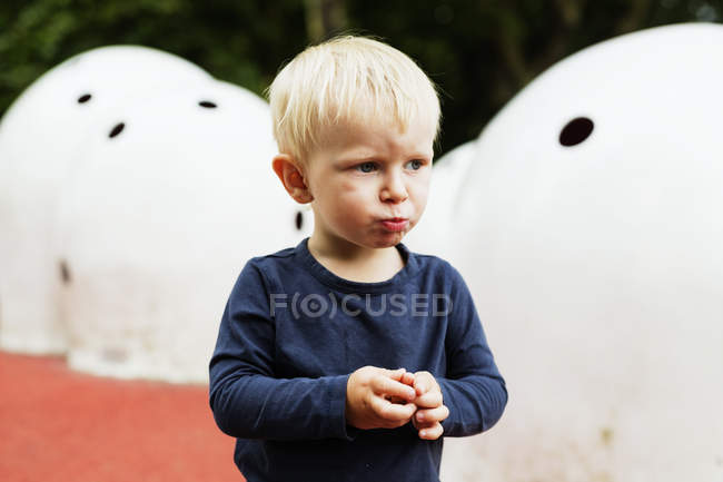 Boy looking away while pouting — Stock Photo