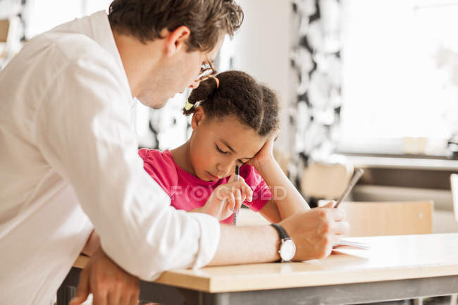 Teacher teaching girl — Stock Photo