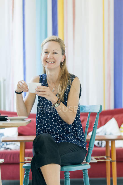 Woman having coffee in cafe — Stock Photo