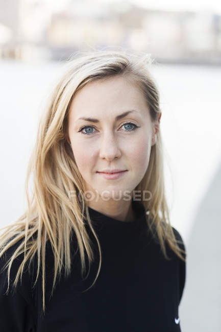 College student looking at camera outdoors — Stock Photo