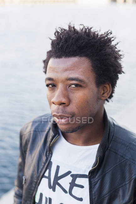 Male college student by river — Stock Photo