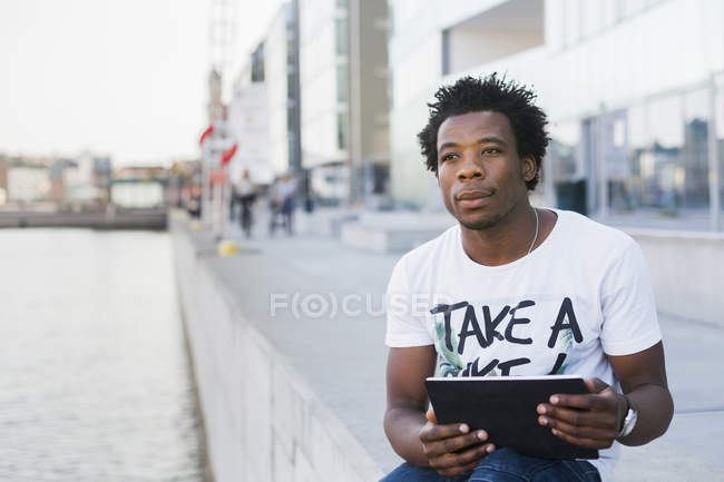 College student holding digital tablet — Stock Photo