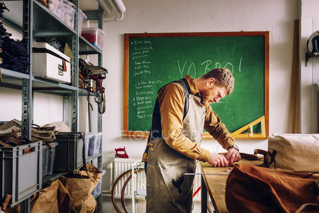 Male worker in bag factory — Stock Photo